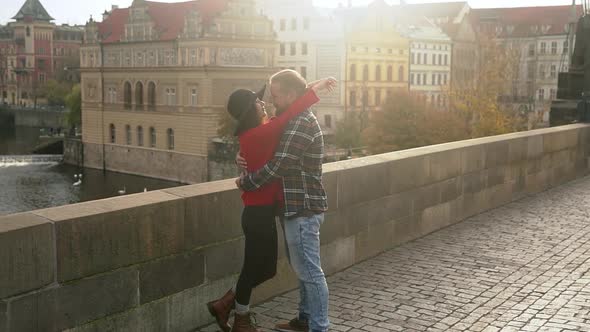 Sweet Couple Have Romantic Date in Old European Town on the Sunset Bridge alt