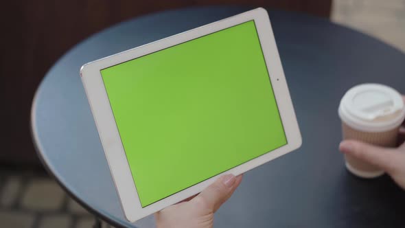 Close-up of Tablet Green Screen in Female Caucasian Hands. Unrecognizable Woman Using Social Media alt