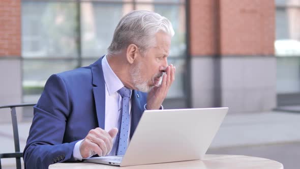 Sick Old Businessman Coughing While Working on Laptop Outdoor alt