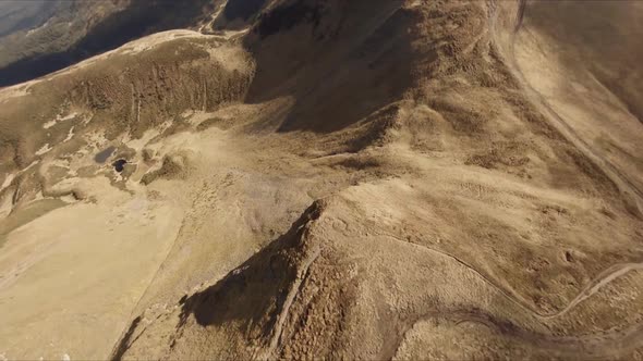 FPV Drone Footage Smooth Stabilized Fly Along Mountain Rocky Hill Around Highland Lake alt