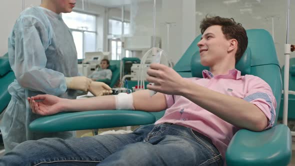 Young Man Getting Blood Donor Agreement alt