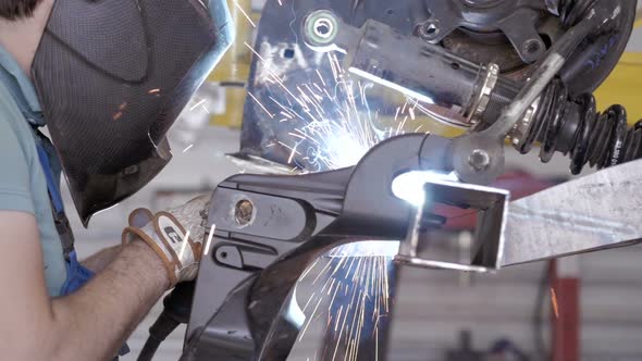 Welding Process. Worker Doing Welding Job. A Man Doing Welding Parts alt