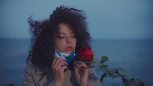 Closeup Girl Takes Off the Medical Mask and Sniffs the Rose