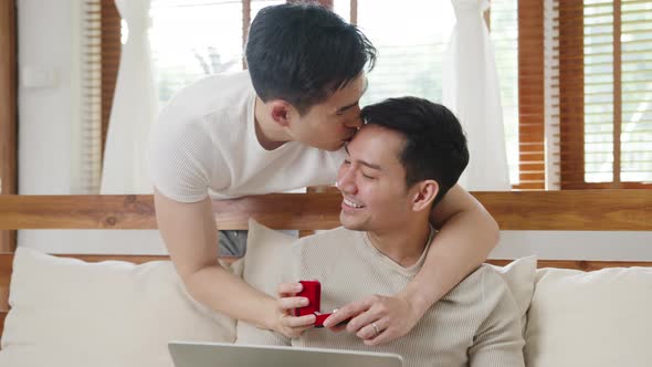 Asia gay couple propose at modern home, LGBTQ men happy smiling have romantic time. alt