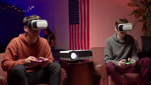 Young Men in Headsets Playing Virtual Videogame Together