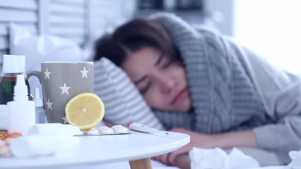 Sick Woman Lying On Bed With Flu At Grey Bedroom alt
