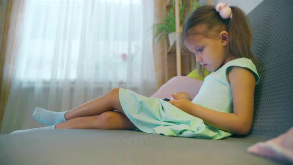 Girl Child Preschooler Uses Smartphone alt