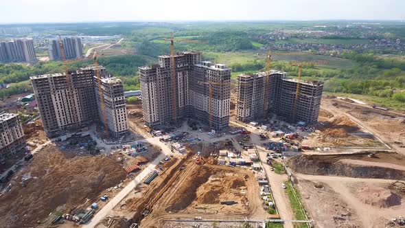 Drone flies over a construction site near Moscow. Construction cranes in the industrial zone. 