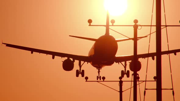 Jet Landing At Airport At Sunset alt