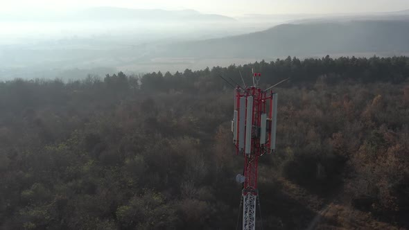 Ascending over the top of telecommunication tower 4K drone video alt