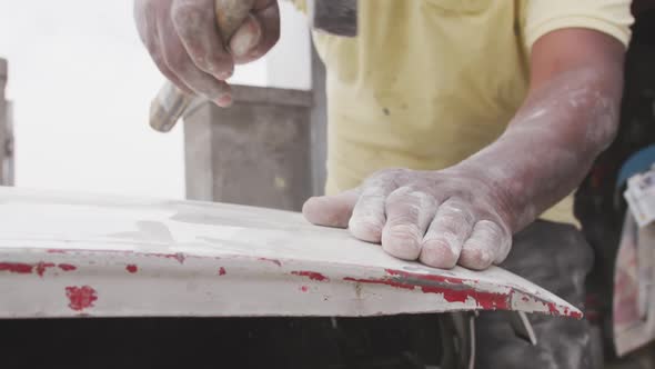 African man repairing car alt