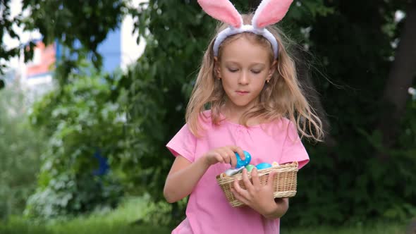 Little Girl Searching for Easter Eggs Outdoors alt