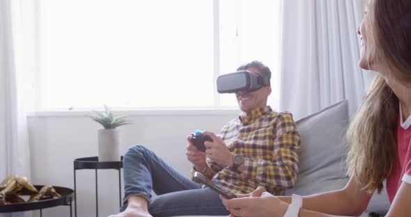 Beautiful woman using mobile phone and man playing game on virtual reality headset 4k