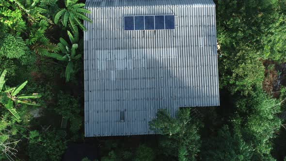 Aerial drone camera view of residential house in the forest,ecological energy power nature concept alt