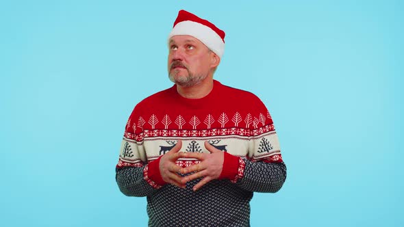 Cheerful Man in Sweater Santa Christmas Hat Getting Present Gift Box Expressing Amazement Happiness alt