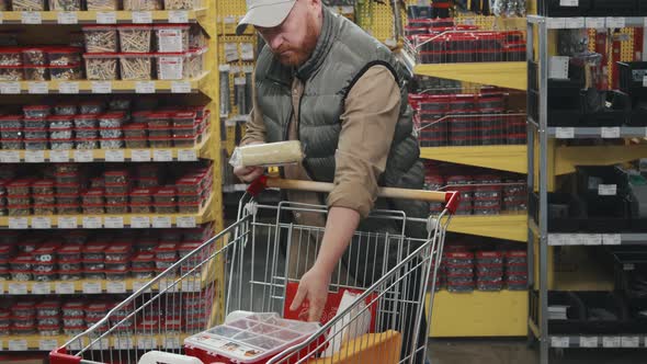 Man Shopping and Posing for Camera at Hardware Store alt