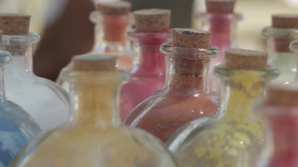 powder dyes of assorted colors to paint in a glass bottle alt