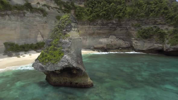 Aerial view of around rock in the ocean on virgin Suwehan beach. Nusa Penida island, Indonesia. alt
