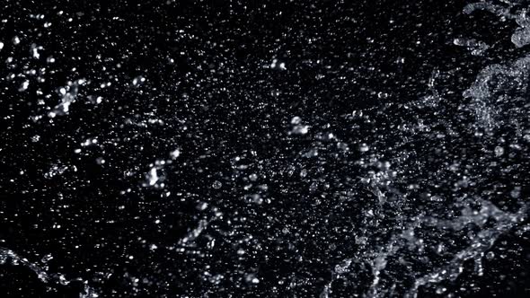 Super Slow Motion Shot of Side Water Splash Isolated on Black Background  alt