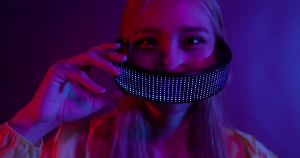 Young Asian woman playing metaverse virtual reality digital technology game with VR goggle. alt