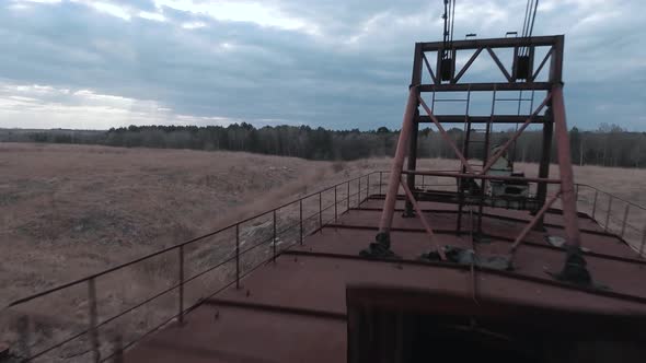 FPV Drone Flies Smoothly Near Rusty Abandoned Walking Excavator alt