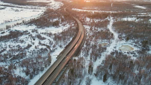 Unusual Winter Landscape with a Motor Road at Sunset Aerial View alt