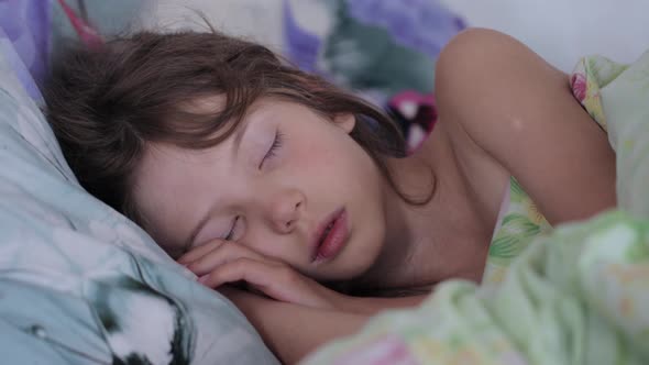 Little girl sleeping in morning light