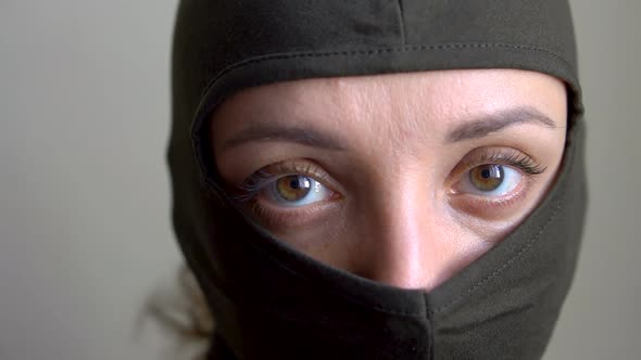 Female Portrait of Young Girl Wearing Khaki Balaclava Only Eyes are Visible Mandatory Conscription alt