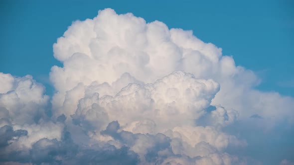 Timelapse of White Puffy Cumulus Clouds Forming on Summer Blue Sky alt