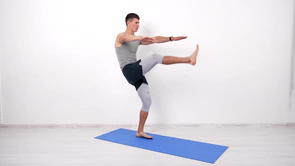 Concentrated Sportsman Doing Abs Exercise with Leg Up on Fitness Mat Motion alt