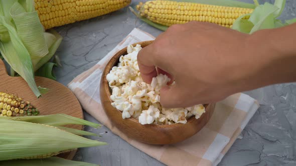 Tasty Traditional Popcorn and Corn Cobs on Grey Background alt