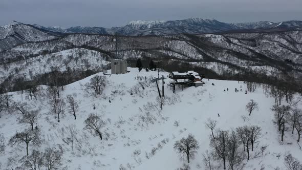 ski lift taking skiers to the snow covered mountain peak in nozawa onsen ski resort in nagano japan, alt