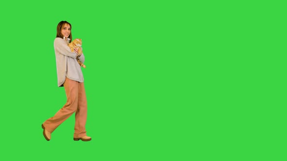 Girl Walking and Holding a Cat on a Green Screen Chroma Key alt