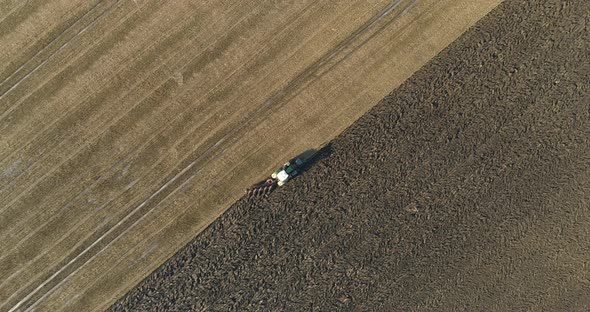 Tractor Plowing Field on Aerial Shot of Agriculture alt