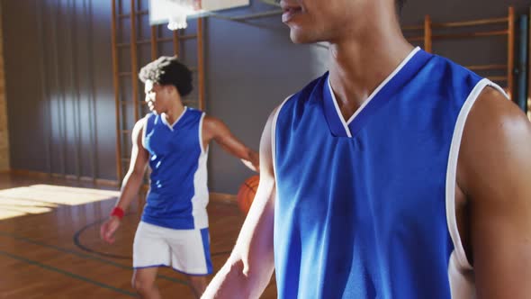 Portrait of african american male basketball player with teammate in background alt