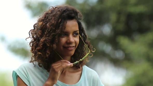 Young Multiracial Female Dancing for Somebody, Taking Her Sunglasses Off, Flirt alt