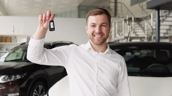Portrait of Happy Adult Successful Man Posing in Auto Showroom Buying New Automobile alt