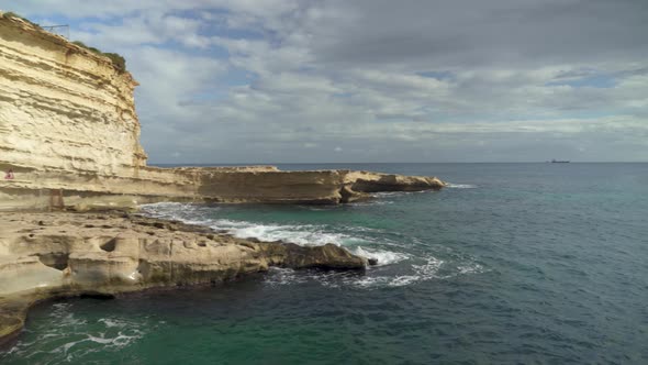 Panoramic View of St Peters Pool Stone Beach with Limestone Slope and Mediterranean Sea
