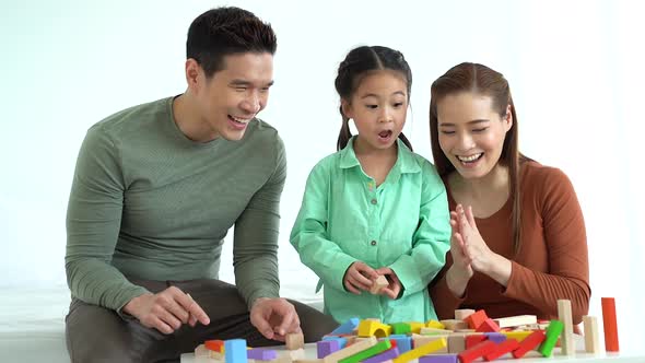 Portrait of Young Asian Family Clapping and Playing with Toy Blocks alt