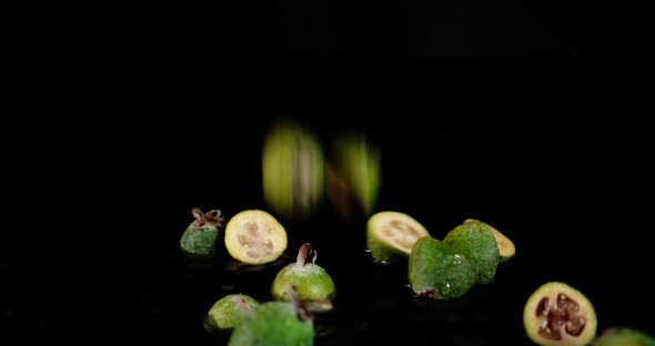The Feijoa Slices Fall on the Water with Splashes.  alt