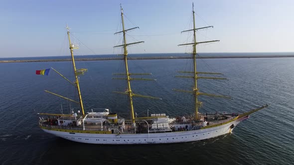 Romanian Navy training ship "Mircea" near the coastline on a sunny day in the Black Sea.