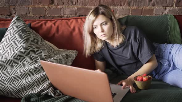 Lady at Home Worried Looking at Laptop Display