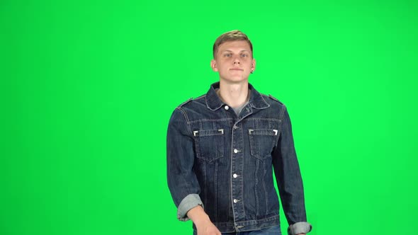 Young Man Walking and Greeting on a Green Screen, Chroma Key alt
