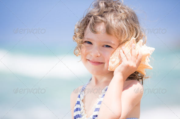 Child with seashell - Stock Photo - Images