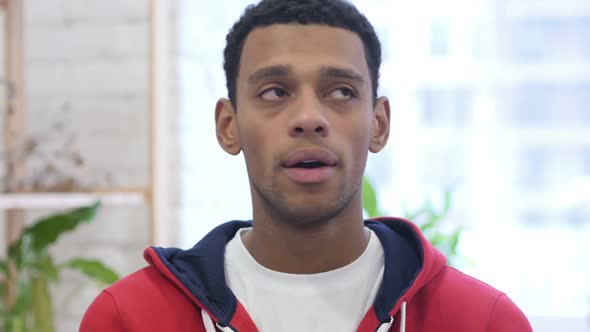 AfroAmerican Man Waiting and Watching Time on Smartwatch alt