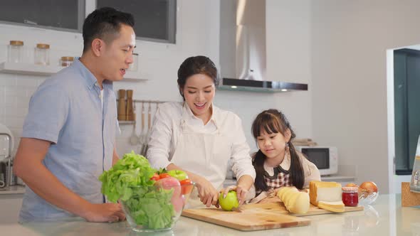 Family relationship, Asian happy family making food preparation with kid in kitchen room at house. alt