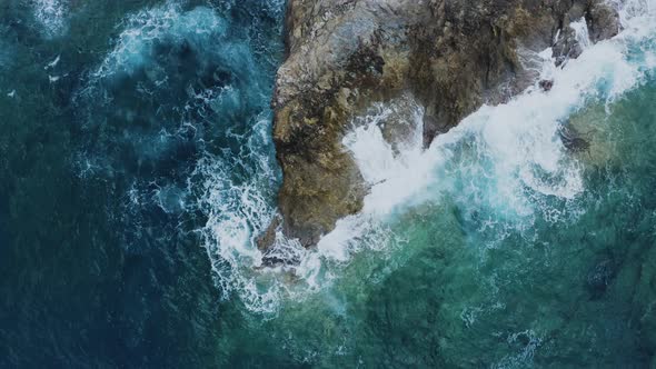 Aerial of Waves Crashing of Rocks. Flying above Turquoise Waves alt