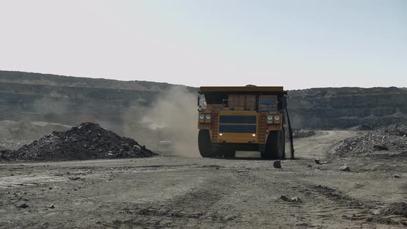 Hard Coal Spills Out of a Crowded Mining Truck on a Sharp Curve