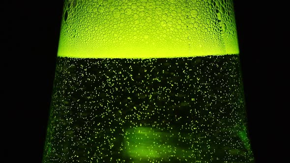 A Green Bottle neck with a lot of bubbles