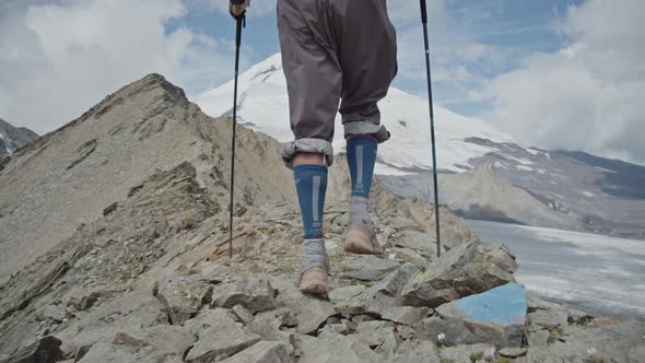 Following the Man Walking on a Ridge in a Big Mountains